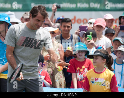 Brisbane, Australia. 30th Dec, 2013. Roger Federer of Switzerland plays with kids during 'Kids day' event at Brisbane International tennis tournament in Brisbane, Australia, Dec. 30, 2013. Credit:  Bai Xue/Xinhua/Alamy Live News Stock Photo