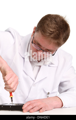 a man with a screwdriver disassembles a computer hard drive repair Stock Photo