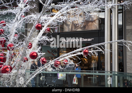 Pull & Bear  Christmas shops decorations and shoppers in Liverpool One, Merseyside, UK Stock Photo