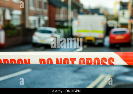 Belfast, Northern Ireland. 30 Dec 2013 - Police Tape stretched across Parkgate Avenue in East Belfast was closed following the discovery of a suspicious object.  Army ATO were tasked to examine the object. Credit:  Stephen Barnes/Alamy Live News Stock Photo