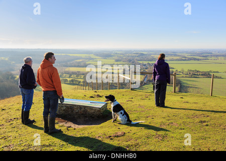 People with dog looking at a view west from viewpoint in Wye National Nature Reserve on North Downs Way in hills near Ashford Kent England UK Britain Stock Photo