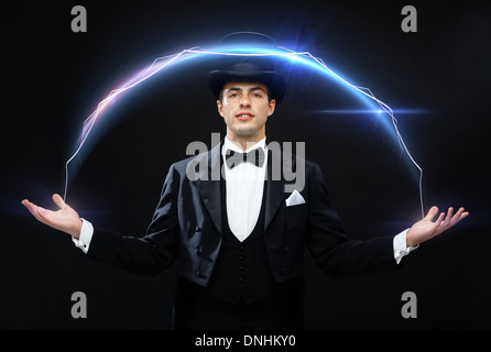 magician in top hat showing trick Stock Photo