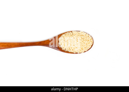 Sesame seeds on wooden spoon isolated on white background. Stock Photo