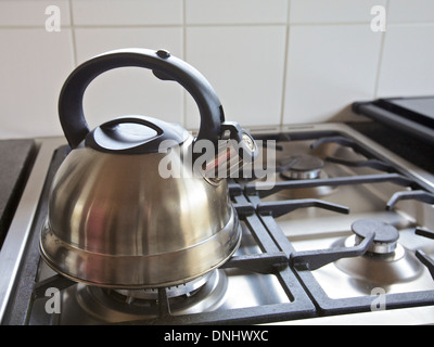 Kettle on a gas stove int a kitchen, home Stock Photo