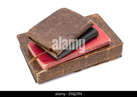 An aged stack of leather bound books on a white background. Stock Photo