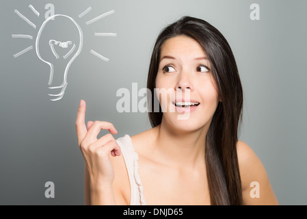 Young brunette woman has an idea to a problem Stock Photo
