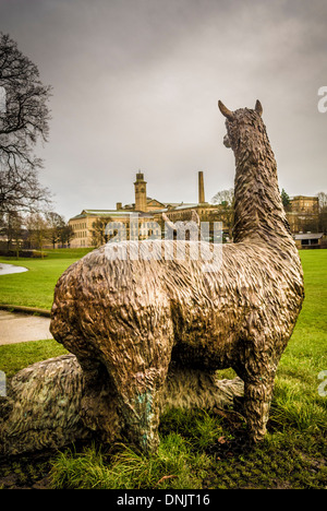 Roberts Park's statue of Alpacas seen from behind with New Mill and Salts Mill in the distance.  Saltaire, West Yorkshire. Stock Photo