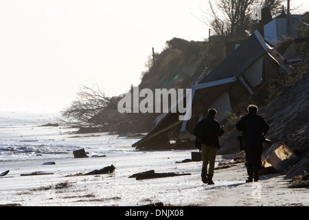 Press photographers approach wreckage of collapsed house at Hemsby during tidal surge of 6th December 2013 Stock Photo