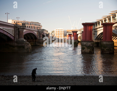 A fisherman by the river Thames near the old Blackfriars Bridge, London, England, UK Stock Photo