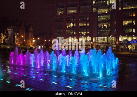 Blue illuminated coloured fountains in Piccadilly Gardens as Manchester's hosted privately sponsored New Year's Eve celebrations and fireworks display, with Big Wheel and Michael Jackson’s Thriller helping usher in 2014. Stock Photo