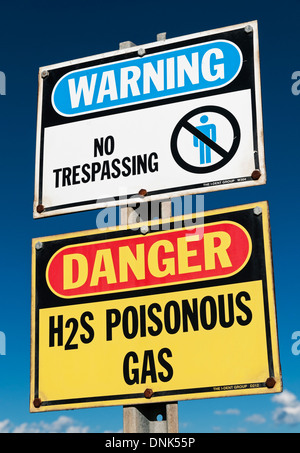 Warning signs: no trespassing and poisonous H2S ( hydrogen sulphide) gas, near Olds, Alberta, August 19, 2013. Stock Photo