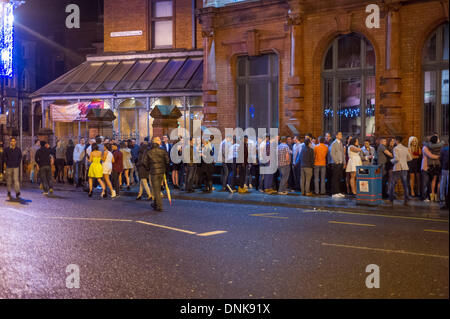 Cardiff, Wales, UK. 31st December 2013. Long queues to get into Oceana. People gathered in the Welsh capital to see in the beginning of 2014. Credit:  Polly Thomas / Alamy Live News Stock Photo