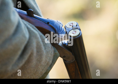 A man holding a 12 bore or gauge shotgun on a pheasant shoot in England Stock Photo