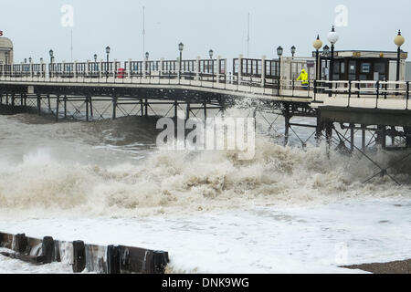 Worthing, UK, 01/01/2014 : Stormy Weather on New Years Day. A man watches the waves crash against Worthing Pier. Picture by Julie Edwards Stock Photo