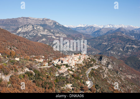 AERIAL VIEW. Perched medieval village with the Mercantour Alps on the horizon. Bouyon, Alpes-Maritimes, French riviera's hinterland, France. Stock Photo