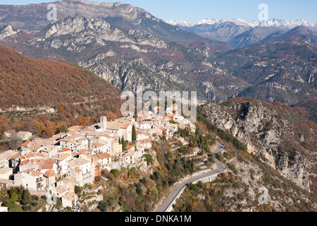 AERIAL VIEW. Perched medieval village with the Mercantour Alps on the horizon. Bouyon, Alpes-Maritimes, French riviera's hinterland, France. Stock Photo
