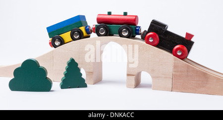 wooden toy train on bridge in grey background. horizontal image Stock Photo