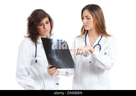 Two female doctors watching a radiography isolated on a white background Stock Photo