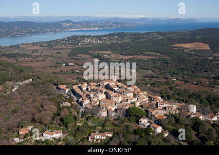 AERIAL VIEW. Perched medieval village overlooking the Saint-Tropez Gulf and the snowcapped Mercantour Mountains in the distance. Gassin, Var, France. Stock Photo