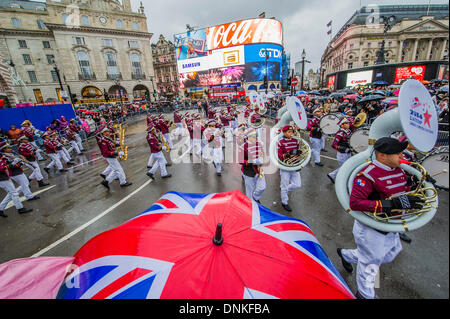 London, UK. 01st Jan, 2014. A new year's day parade passes through Piccadilly Circus on a wet and windy day. London, UK 01 Jan 2014. Credit:  Guy Bell/Alamy Live News Stock Photo