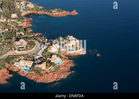 AERIAL VIEW. Beautiful waterfront villas in an idyllic and colorful setting. Le Trayas, Saint-Raphaël, Estérel Massif, Var, French Riviera, France. Stock Photo