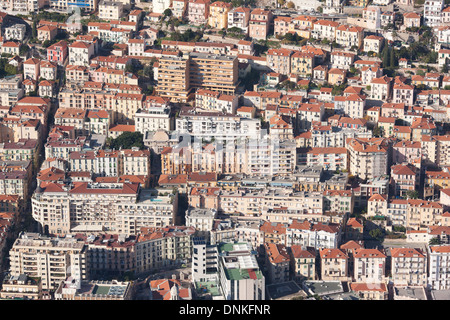 AERIAL VIEW. High density of apartment buildings on a steep hillside. Principality of Monaco (lowest half) and Beausoleil, France (highest half). Stock Photo
