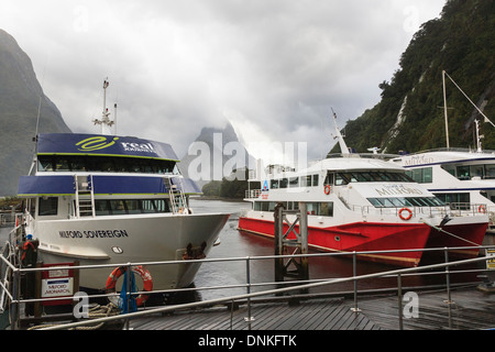 Tourists's cruise boats by quay for tours of Milford Sound, Fiordland National Park, Southland, South Island, New Zealand Stock Photo