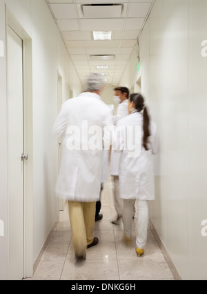 Medical Professionals Walking In Corridor Stock Photo