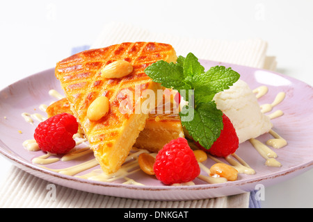 Almond cake with ice cream and fresh raspberries Stock Photo