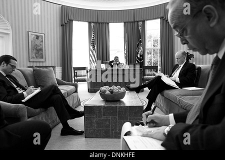 US President Barack Obama sips a cup of tea while talking on the phone with Chinese President Xi Jinping in the Oval Office of the White House March 14, 2013 in Washington, DC. Stock Photo