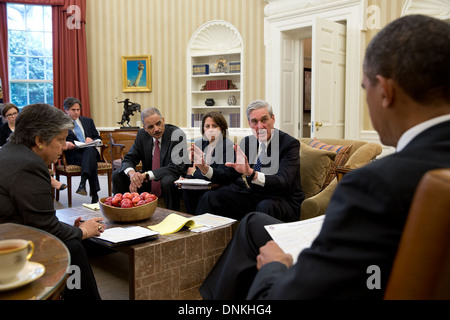 US President Barack Obama receives an update from his security team on the explosions that occurred in Boston during a briefing in the Oval Office of the White House April 16, 2013 in Washington, DC. Seated, from left, are: Homeland Security Secretary Janet Napolitano; Tony Blinken, Deputy National Security Advisor; Jake Sullivan, National Security Advisor to the Vice President; Attorney General Eric Holder; Lisa Monaco, Assistant to the President for Homeland Security and Counterterrorism; Chief of Staff Denis McDonough; and FBI Director Robert Mueller. Stock Photo
