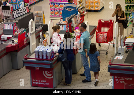 Overhead view of man paying at supermarket checkout counter Stock Photo