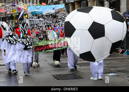 London, UK. 1st January 2014. Tens of thousands of people braved dreadful weather in central London this afternoon for the capital's annual New Year's Day parade, January 1st 2014, Photo by See li/Alamy Live News