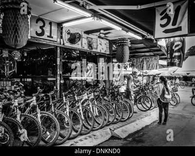 A tourist bargains for a rental bicycle in Pulau Ubin Island, Singapore Stock Photo