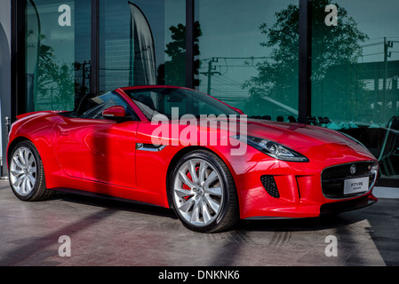 Jaguar F type. Full length side view of a red  British convertible sports car Stock Photo