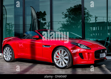 Jaguar F type. Full length side view of a red  British convertible sports car Stock Photo
