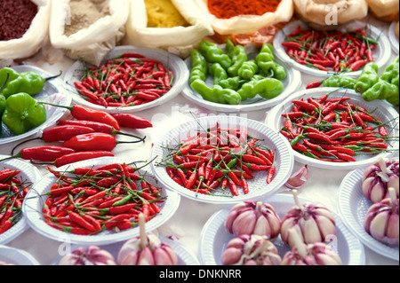 Fresh red and green hot peppers garlic and spices at outdoor Brazilian farmers market Stock Photo
