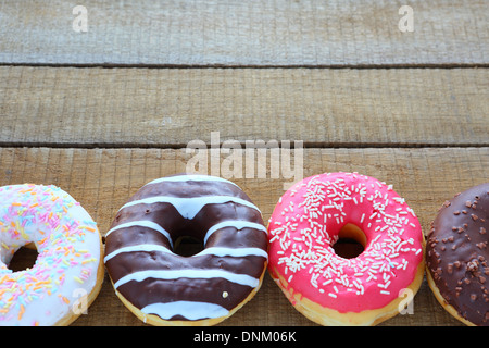 round donuts with colored glaze, food closeup Stock Photo