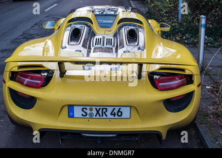 STUTTGART, GERMANY – JANUARY 1, 2014: A new Porsche 918 Spyder  prototype is parked in the streets of its hometown Stuttgart on January 1, 2014 in Stuttgart, Germany. The Porsche 918 Spyder is featuring hybrid concept using a V8 motor plus two electronic motors, featuring 887 horsepower altogether with a consumption of combined about 3.3 liters per 100 kilometers. It will be sold as a limited edition of 918 cars, costing about 768.000 EUR each. Stock Photo