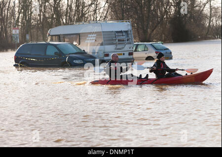 Yalding, Kent, UK. 2nd January 2014. The Environment Agency has issued a flood warning for Yalding Village in County of Kent the first one for 2014 on Thursday 2nd January.  Carpark at hampstead lane and sunken cars with canoeists exploring new waterways Credit:  Yon Marsh/Alamy Live News Stock Photo