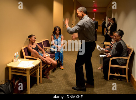 US President Barack Obama shows off his dance moves as he and the First Lady waited backstage during an intermission of daughter Sasha's dance recital at Strathmore Arts Center June 16, 2013 in North Bethesda, Maryland. Stock Photo
