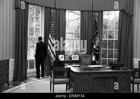 US President Barack Obama looks out the window of the Oval Office August 29, 2013 in Washington, DC. Stock Photo