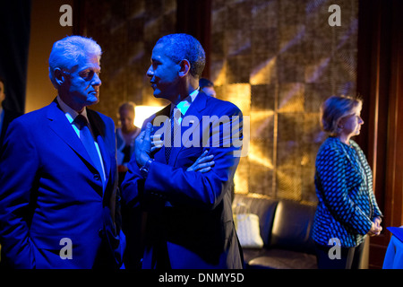 US President Barack Obama and former President Bill Clinton are bathed in blue light as they talk backstage prior to participating in the Clinton Global Initiative Healthcare Forum September 24, 2013 in New York City, NY. Stock Photo