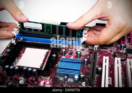 Man installing memory. PC motherboard RAM upgrade Stock Photo