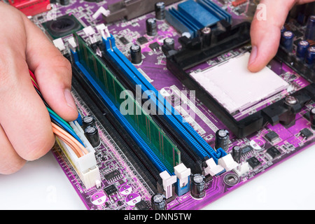 Technician repairing computer hardware Stock Photo