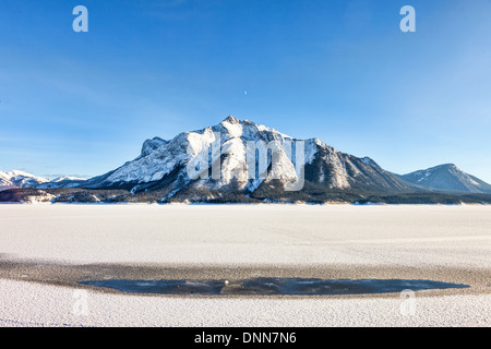 Snow Mountain and Frozen Lake in the Canadian Rockies Stock Photo