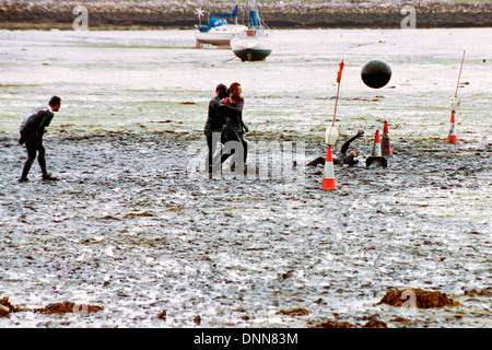 traditional game of mud football on langstone locks mud flats portsmouth england uk Stock Photo