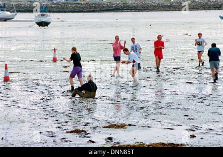 traditional game of mud football on langstone locks mud flats portsmouth england uk Stock Photo