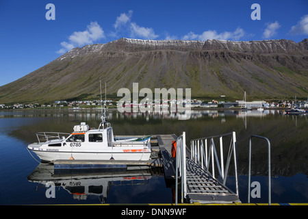 Boat on jetty in Isafjordur Westfjords Iceland with view across fjord Stock Photo