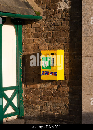 Automated External Defibrillator on Egleton Village Hall wall, Rutland, England, UK Stock Photo